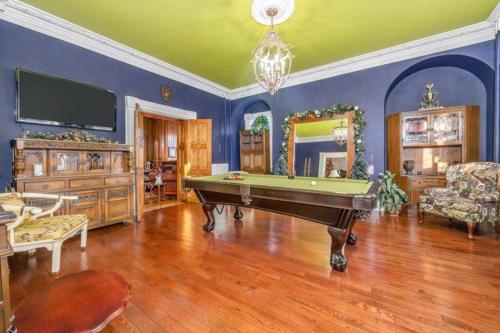 a living room with a pool table and a tv at Lakehurst Estate in Cobourg