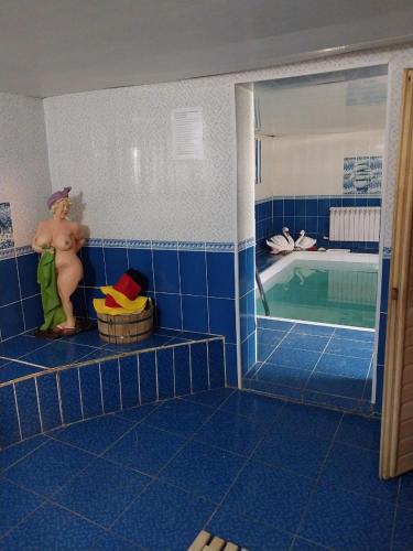 a shirtless man sitting in a bathroom with a pool at Апарт-Отель Энглер in Novorossiyskoye