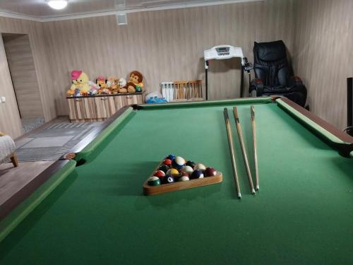 a room with a pool table with balls and bats at Апарт-Отель Энглер in Novorossiyskoye