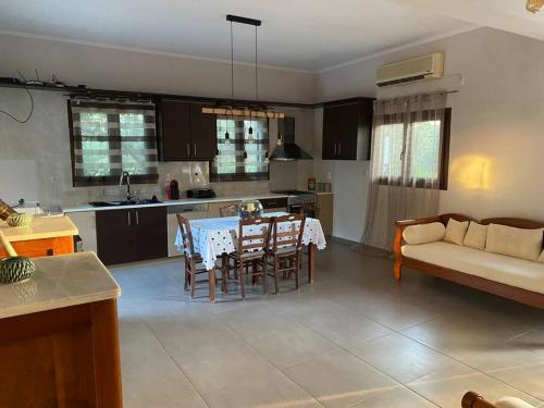 a kitchen and living room with a table and chairs at Limenari modern house in Filiatra