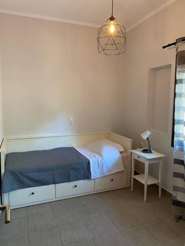 a bedroom with a bed and a table with a lamp at Limenari modern house in Filiatra