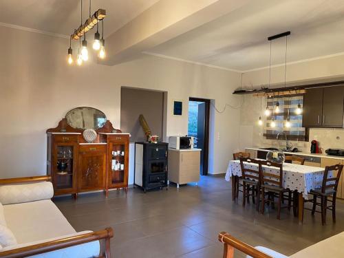 a large kitchen and dining room with a table and chairs at Limenari modern house in Filiatra