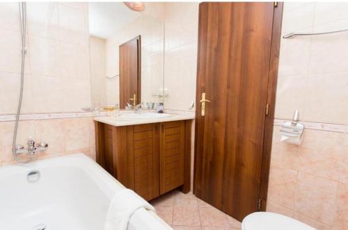 uma casa de banho com uma banheira, um lavatório e um WC. em Sea view apartment Kaliakria resort em Topola