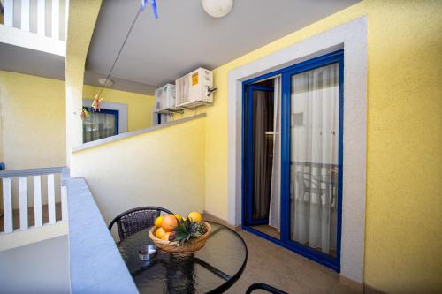 a table with a basket of fruit on a balcony at Tanja Apartments in Rafailovici