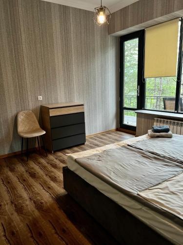 a bedroom with a large bed and a window at Tranquille Dilijan in Dilijan