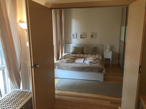 a bedroom with a bed and a large mirror at Apartament z Tarasem in Świnoujście