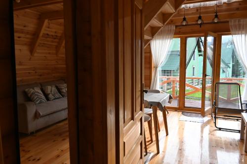 a living room with a couch and a table at Aleksa’s chalet in Žabljak