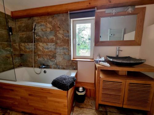 a bathroom with a bath tub and a sink at Villa Alyzea in Bessan
