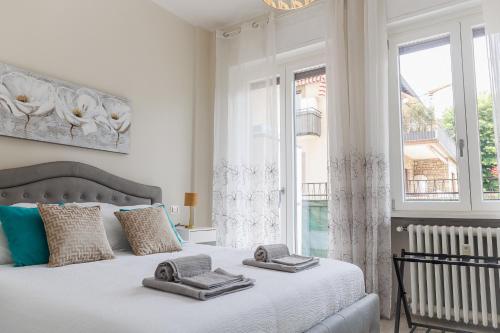 a bedroom with a bed with two towels on it at SNT Apartment - City Center in Bergamo