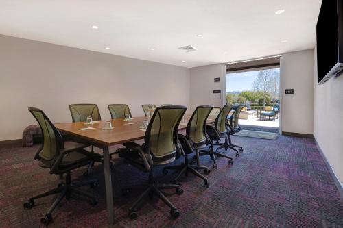 a conference room with a long table and chairs at Home2 Suites By Hilton Petaluma in Petaluma