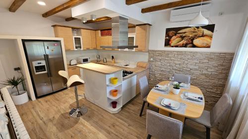 a kitchen with a table and a counter top at Villa Umbra et Sol in Gruda