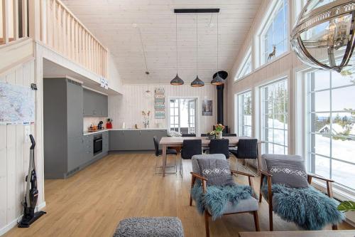 a kitchen and dining room with a table and chairs at Holiday home in beautiful Sjusjøen, near Lillehammer in Ringsaker