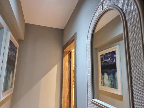 a bathroom with a mirror and a framed mirror at EXQUISITE GOLF VILLA with Sea, 8Tee, Green Views, in Aphrodite Hills Golf Resort in Kouklia