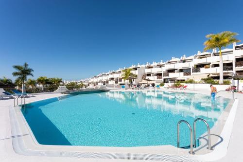 a large swimming pool in front of a hotel at The Paradise suites by ANNE, Cozy apartment in Adeje in Adeje