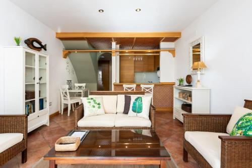 a living room with two couches and a coffee table at The Paradise suites by ANNE, Cozy apartment in Adeje in Adeje