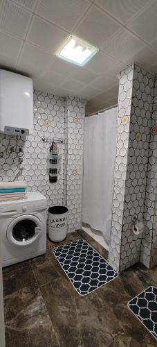 a bathroom with a washing machine and a washer at Amazing Seaview Flat in Kuşadası