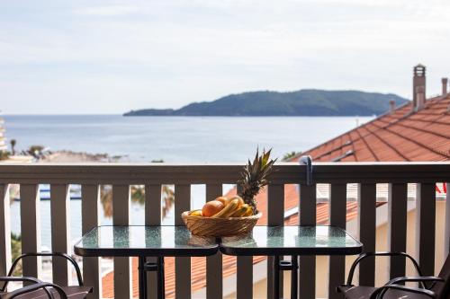 a basket of fruit on a table on a balcony at Tanja Apartments in Rafailovici