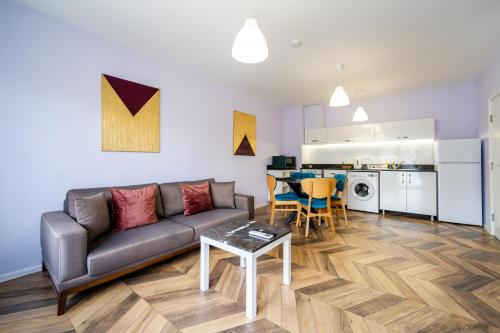 a living room with a couch and a table at Sunny Apartment in Studentski grad, behind UNSS in Sofia