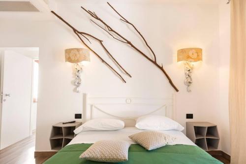 a bedroom with a white bed with two pillows at Villa Picarielli in Salerno