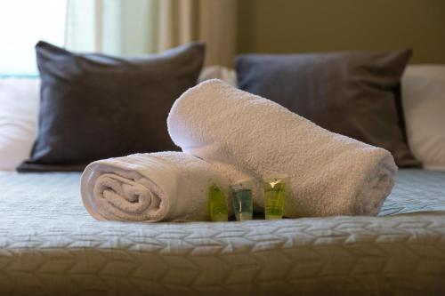 a rolled up towel on a bed in a hotel room at Stylish Retreat in Hove