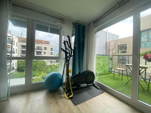 a room with a gym with a large window at Logement spacieux avec chambre privée in Noisy-le-Grand
