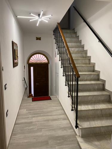 a hallway with stairs with a ceiling fan at B&B al Vicoletto in Bellante