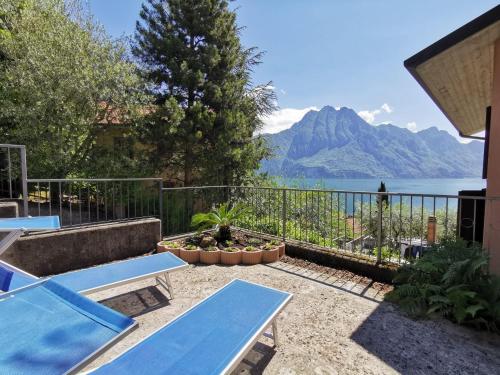 a patio with a view of the water and mountains at Appartamento Gelsomino in Riva di Solto