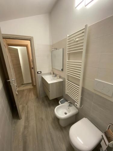a bathroom with a toilet and a sink at B&B al Vicoletto in Bellante
