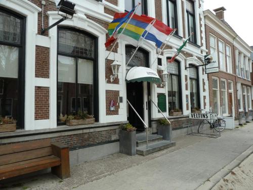 a building with a rainbow flag on a street at Hotel Centraal in Harlingen