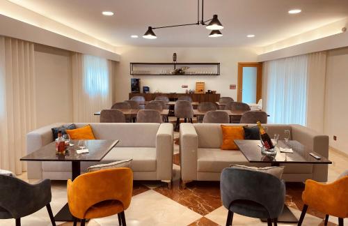 a living room with a couch and tables and chairs at Casa de Lamaçais in Vilela
