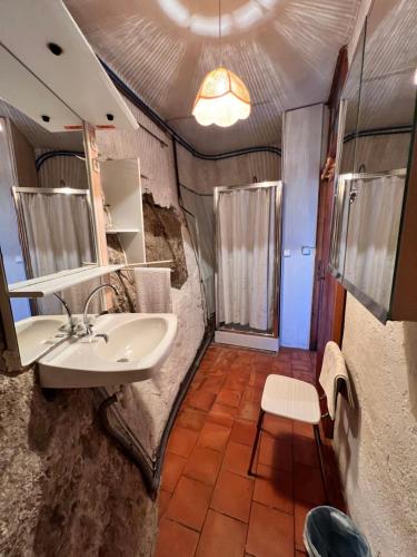 een badkamer met een wastafel en een spiegel bij LES GITES D'ARDAILLERS in Valleraugue