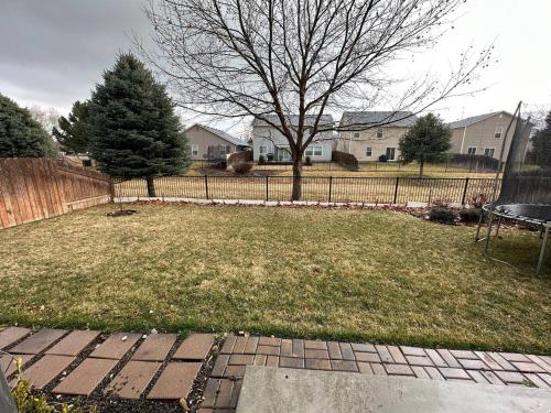 a yard with a fence and a tree at 2 Story Meridian Home in Meridian