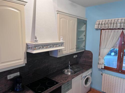 a kitchen with a sink and a stove top oven at Chalet Major Beach Sanxenxo in Sanxenxo