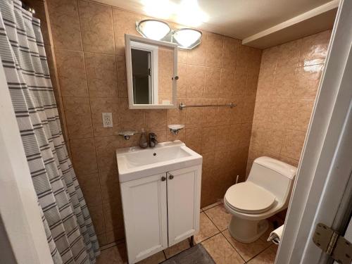 a bathroom with a white sink and a toilet at 3 Level 4 Bedroom Home w/ Parking in Adams Morgan in Washington