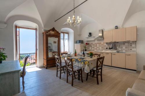 a kitchen and dining room with a table and chairs at Agriturismo Il Vecchio Mulino in Terzorio