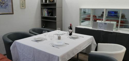 a table with a white table cloth and wine glasses at Vacational apartment in Bottrop