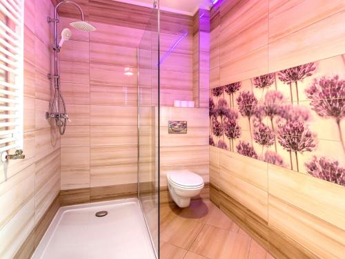 a bathroom with a toilet and a glass shower at Apartamente Simona Brasov in Braşov