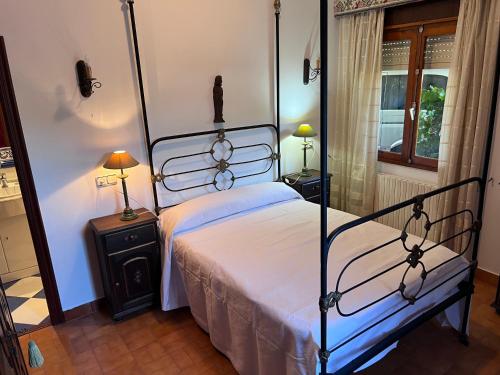 a bedroom with a bed and two night stands with lamps at Chalet Major Beach Sanxenxo in Sanxenxo