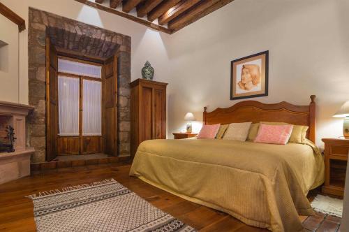 a bedroom with a large bed in a room at Hotel Casa del Naranjo in Pátzcuaro
