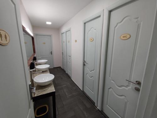 a bathroom with two sinks and two toilets at ATI MTA - Eco Hostel in Borjomi