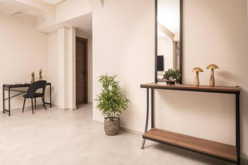 a living room with a table and a mirror at Villa Adiola, An Unrivalled Retreat in Kalamaki