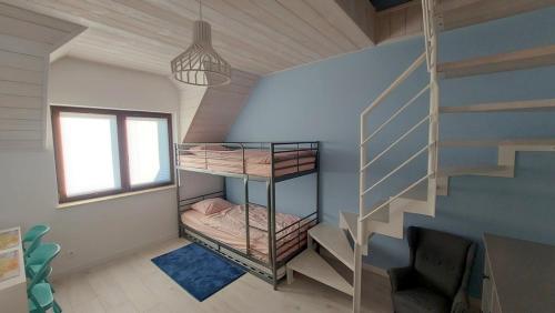 a small room with bunk beds and a staircase at Ostoja Rydzewo A in Rydzewo
