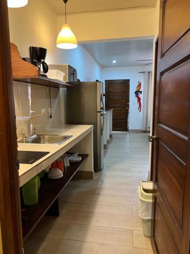 uma cozinha com um lavatório e uma bancada em Cabinas El Colibri em Puerto Carrillo
