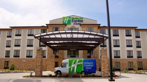 a truck parked in front of a building at Holiday Inn Express & Suites St Louis Airport by IHG in Woodson Terrace