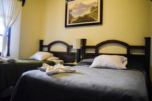 Cama o camas de una habitación en Dionisio Inn