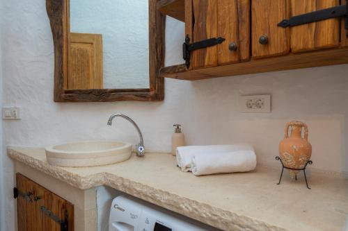 een aanrecht met een spoelbak en een spiegel bij Villa Viva Brac - Pool - Meerblick in Povlja