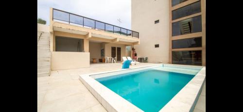 a house with a swimming pool next to a building at Flat Terreo n1 Porto de Galinhas c Piscina in Porto De Galinhas