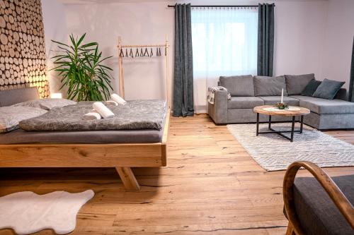 a living room with a bed and a couch at Apartmány Belá in Spišská Belá