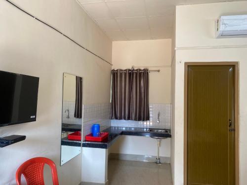 a bathroom with a sink and a mirror at Atithya Lodge in Guwahati