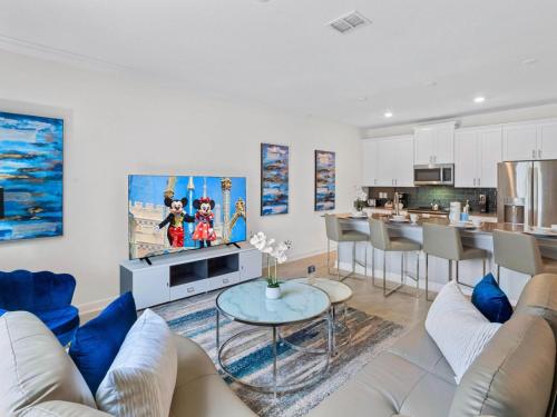 a living room with a couch and a table at Gorgeous Condo Close to Disney w Private Pool BBQ - Themed Bedrooms Walk To Clubhouse in Kissimmee